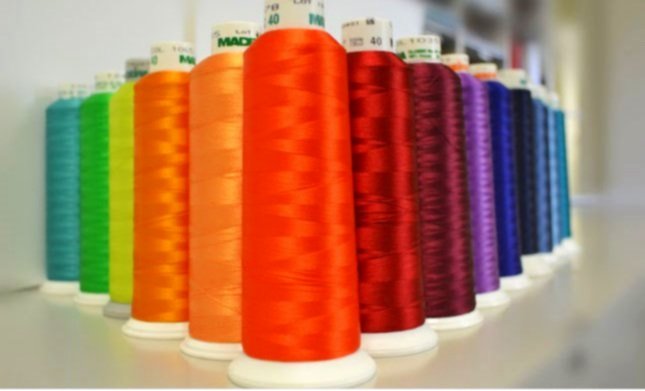 Rows of colorful embroidery thread spools